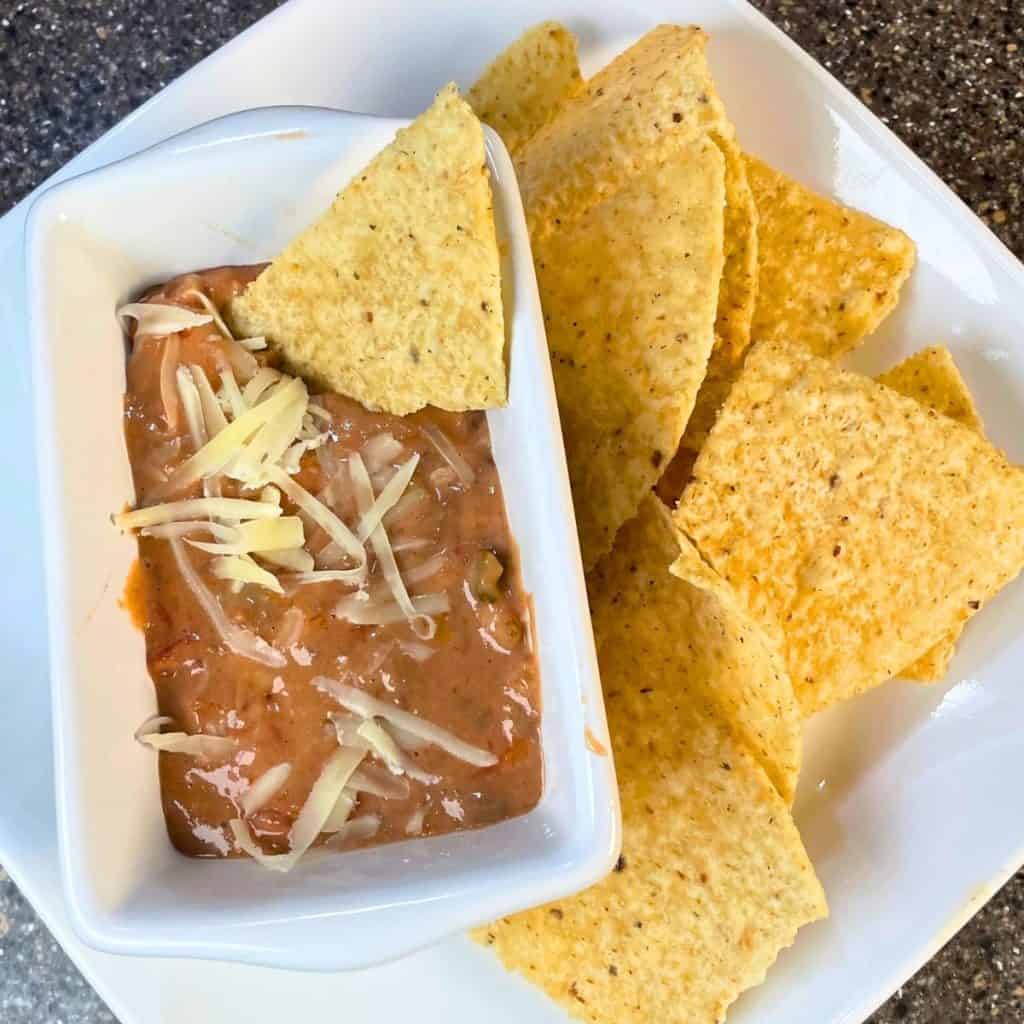venison queso on a plate with chips