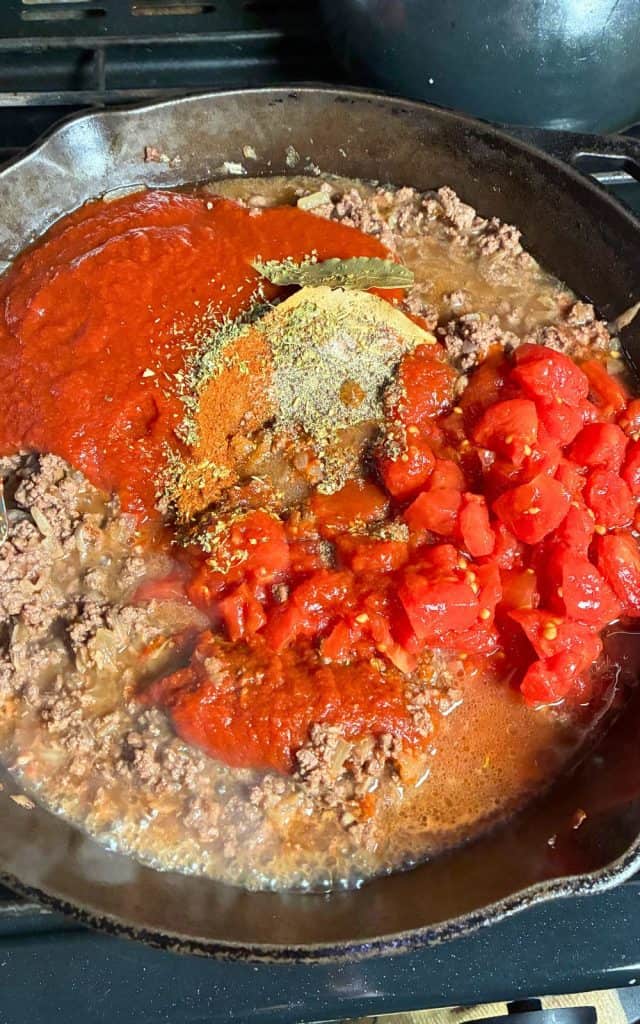 tomato products and spices added to ground venison