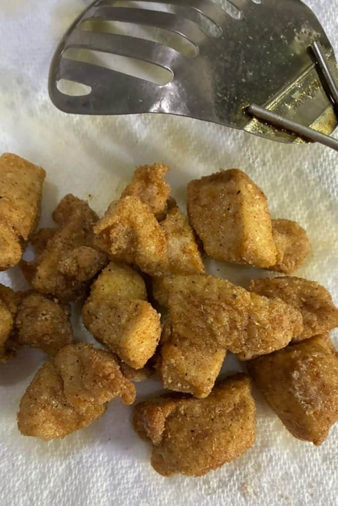 chicken nuggets draining on a papertowel