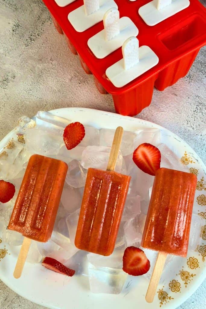 a popsicle mold and popsciles on a plate of ice