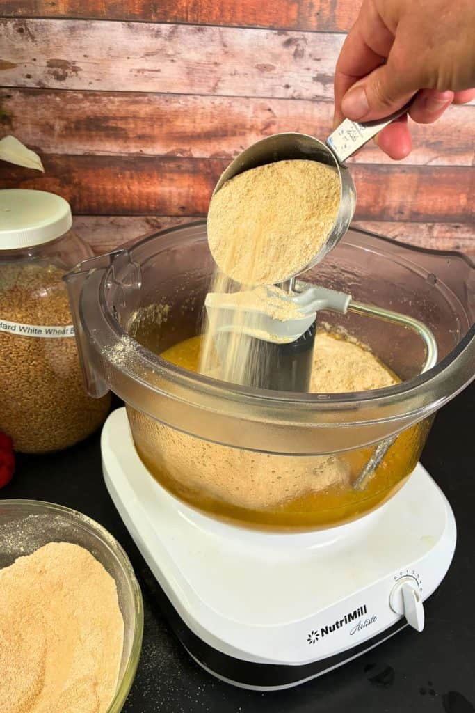 adding flour to sandwich bread dough